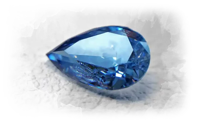 A medium blue cremation diamond made from ashes, pear cut